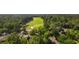 An aerial view of a home surrounded by trees and a golf course nearby for outdoor activities at 1221 Tidewater Dr. # 2112, North Myrtle Beach, SC 29582