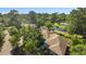 A serene view of residential homes nestled amongst trees, near a pond with a community swimming pool at 1221 Tidewater Dr. # 2112, North Myrtle Beach, SC 29582
