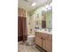 Bright bathroom featuring a shower with curtain, toilet, vanity and mirror at 1221 Tidewater Dr. # 2112, North Myrtle Beach, SC 29582