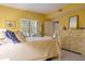 Sunny yellow bedroom with white furniture, including a bed, nightstand, and dresser at 1221 Tidewater Dr. # 2112, North Myrtle Beach, SC 29582