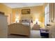 Yellow bedroom with white furniture, including a queen bed, nightstand, and dresser at 1221 Tidewater Dr. # 2112, North Myrtle Beach, SC 29582