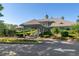 Elegant clubhouse exterior showcasing lush landscaping, a porte cochere, and well-maintained grounds at 1221 Tidewater Dr. # 2112, North Myrtle Beach, SC 29582