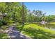 Picturesque community pond with a fountain, walking path, and shaded seating area at 1221 Tidewater Dr. # 2112, North Myrtle Beach, SC 29582
