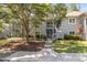 Inviting two-story condo with light gray siding, a beautiful tree and well-maintained landscaping at 1221 Tidewater Dr. # 2112, North Myrtle Beach, SC 29582