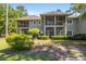 Inviting two-story home featuring double screened porches and a lush, landscaped yard at 1221 Tidewater Dr. # 2112, North Myrtle Beach, SC 29582