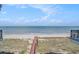Backyard view of a wooden boardwalk leading to a sandy beach and ocean at 123 Pioneer Loop, Georgetown, SC 29440