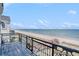 Wrought iron balcony overlooking a picturesque beach and ocean view, complete with a wooden boardwalk at 123 Pioneer Loop, Georgetown, SC 29440