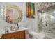 Modern bathroom featuring marble counters, a unique bowl sink, gold sunburst mirror, and glass enclosed shower at 123 Pioneer Loop, Georgetown, SC 29440