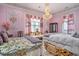 Pink bedroom featuring elaborate trim, crystal chandelier, and luxurious bedding provides a luxurious and whimsical ambiance at 123 Pioneer Loop, Georgetown, SC 29440