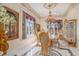 A beautifully appointed formal dining room features an elegant chandelier and large windows draped with red and gold curtains at 123 Pioneer Loop, Georgetown, SC 29440