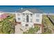 An opulent oceanfront home with classic architecture, including columns and a grand entrance, and a meticulously maintained landscaped yard at 123 Pioneer Loop, Georgetown, SC 29440