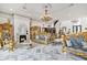 An elegant living room featuring a fireplace, opulent gold detailing, marble floors, and a decorative chandelier at 123 Pioneer Loop, Georgetown, SC 29440