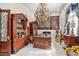 Luxurious office space with a large wooden desk, ornate shelving, and chandelier lighting at 123 Pioneer Loop, Georgetown, SC 29440