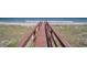 Wooden boardwalk leading to a sandy beach and the ocean, showcasing a peaceful coastal setting at 123 Pioneer Loop, Georgetown, SC 29440