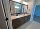 This bathroom features a double sink vanity with black fixtures, and a tiled shower at 1248 Lady Bird Way, North Myrtle Beach, SC 29582