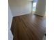 Bright bedroom showcasing wood flooring, neutral walls, and a sunlit window at 1248 Lady Bird Way, North Myrtle Beach, SC 29582