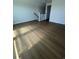 An upstairs bonus room with wood-look flooring featuring natural light and neutral wall colors at 1248 Lady Bird Way, North Myrtle Beach, SC 29582