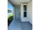A welcoming covered front porch featuring a stylish entry door and complementary trim at 1248 Lady Bird Way, North Myrtle Beach, SC 29582
