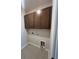 A laundry room featuring upper cabinets and tiled floors for easy cleaning at 1248 Lady Bird Way, North Myrtle Beach, SC 29582