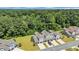 Aerial view of townhomes with attached garages, long driveways, and lush green surroundings at 132 Machrie Loop # A, Myrtle Beach, SC 29588
