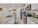 Modern kitchen featuring granite countertops, stainless steel appliances, and sleek white cabinets at 132 Machrie Loop # A, Myrtle Beach, SC 29588