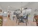 Bright, open kitchen with white cabinets, island with seating, and dining area with natural light at 132 Machrie Loop # A, Myrtle Beach, SC 29588