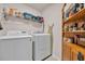 Well-equipped laundry room with modern washer, dryer, shelving and built-in storage at 132 Machrie Loop # A, Myrtle Beach, SC 29588