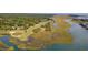 Stunning aerial view showcasing a golf course alongside scenic waterways and lush greenery, offering beautiful views at 1325 Clipper Dr., North Myrtle Beach, SC 29582