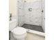 The modern bathroom features a glass-enclosed shower with sleek tilework and a built-in shower seat at 1325 Clipper Dr., North Myrtle Beach, SC 29582
