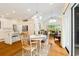 Open dining area with chandelier, sliding glass doors and seamless transition to white kitchen area at 1325 Clipper Dr., North Myrtle Beach, SC 29582