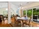 Dining area featuring wood table and chairs, chandelier lighting, and view into the living room with fireplace at 1325 Clipper Dr., North Myrtle Beach, SC 29582