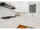 Bright kitchen with white cabinetry, countertops, stainless steel range hood, and a gas cooktop at 1325 Clipper Dr., North Myrtle Beach, SC 29582
