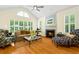 Bright living room with fireplace, large windows, and hardwood floors, offering a cozy and inviting atmosphere at 1325 Clipper Dr., North Myrtle Beach, SC 29582