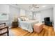 Spacious main bedroom boasts hardwood floors, a ceiling fan, and a cozy sitting area near the window at 1325 Clipper Dr., North Myrtle Beach, SC 29582