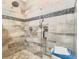 Detailed shower with dual shower heads, tiled walls, and a convenient bench for relaxing at 1325 Clipper Dr., North Myrtle Beach, SC 29582