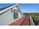 View of the exterior of a balcony showcasing brown decking, white rails, and blue siding at 139 Pioneer Loop, Georgetown, SC 29440