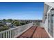 Enjoy stunning neighborhood views from this balcony with wooden deck and white railings at 139 Pioneer Loop, Georgetown, SC 29440