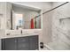 Elegant bathroom featuring vanity, glass shower, modern fixtures, and neutral tiling at 139 Pioneer Loop, Georgetown, SC 29440