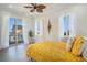 Bright bedroom with a yellow patterned bed and sliding door to the balcony at 139 Pioneer Loop, Georgetown, SC 29440