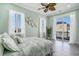 Bedroom with palm patterned bedding, a ceiling fan, and access to a balcony at 139 Pioneer Loop, Georgetown, SC 29440
