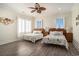 Bedroom with wood flooring, two beds, and ocean themed decorations at 139 Pioneer Loop, Georgetown, SC 29440