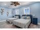 Charming bedroom features two beds, a ceiling fan, and nautical themed decorations at 139 Pioneer Loop, Georgetown, SC 29440