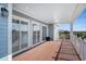 Covered deck with wood flooring and white railings overlooking lush landscaping at 139 Pioneer Loop, Georgetown, SC 29440