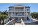 Beautiful multi-story coastal home with multiple balconies, stairs, and lush landscaping at 139 Pioneer Loop, Georgetown, SC 29440