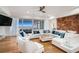 Bright living room with ocean views, white furnishings, hardwood floors, and a geometric accent wall at 139 Pioneer Loop, Georgetown, SC 29440