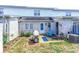 Cozy back patio area with a blue accent chair and outdoor cooking space at 1437 Baldwin Ct. # 1437, Little River, SC 29566