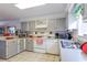Functional kitchen with ample cabinet space, white appliances, and well-lit counters at 1437 Baldwin Ct. # 1437, Little River, SC 29566