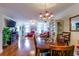 Open-concept living room and dining area with hardwood floors and a charming chandelier at 1437 Baldwin Ct. # 1437, Little River, SC 29566