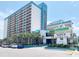 Bright oceanfront view of the Landmark Resort with palm trees and on-site parking at 1501 S Ocean Blvd. # 239, Myrtle Beach, SC 29577