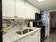 Bright kitchen with granite countertops, stainless steel sink, and white cabinets at 1501 S Ocean Blvd. # 239, Myrtle Beach, SC 29577